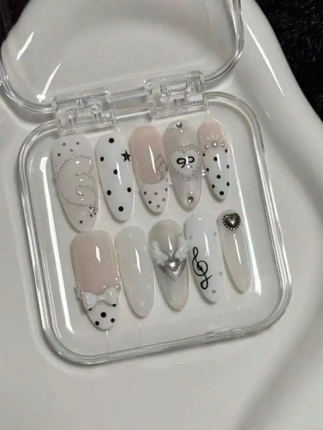 【Exquisitely Crafted, High-Quality Handmade Items】10 Pieces of Handmade Almond-Shaped Full-Cover Nail Tips, Medium-Length, with a Nude White Gradient Base Color Paired with Black Polka Dots, Musical Notes, Stars, 3D Heart Wings, and Bow Decorations, Featuring a Smooth and Delicate Finish, Korean-Style Minimalist Sweet Girl Style, Suitable for Women and Girls, Perfect for Summer Vacations, Graduation Season, and Ideal as a Gift, Includes 1 Piece of Jelly Glue and 1 Nail File.