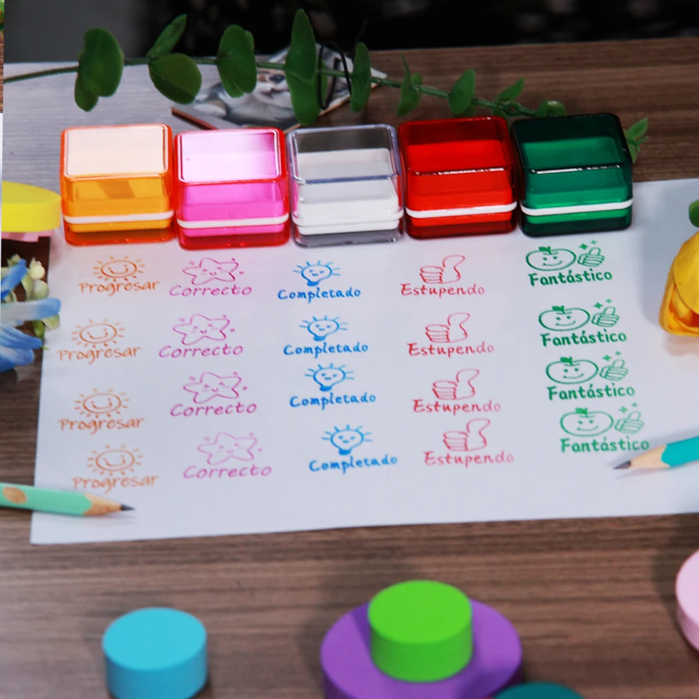 A 5-piece set of colored Spanish teacher stamps for praise, encouragement and correction, essential for class