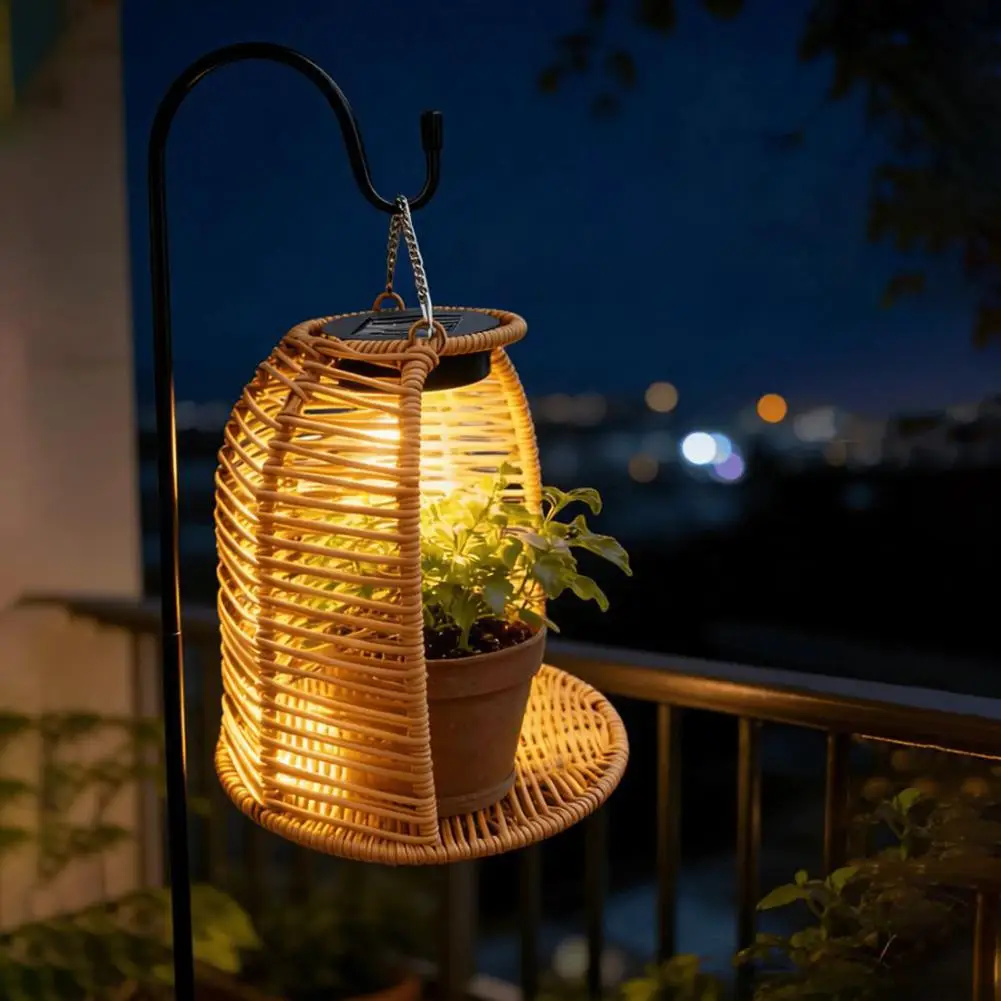 AuraCraft solar lantern hanging from a garden branch casting warm ambient shadows