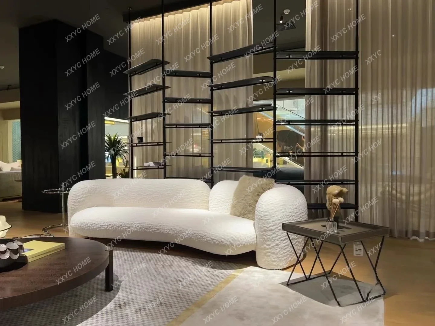 A modern simple curved sofa designer creative small apartment living room beauty salon cream wind fabric sofa