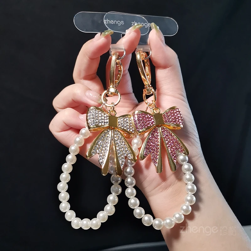 

Xiaoxiangfeng Pearl Phone Chain Fashion Women's Wrist Sparkling Diamond Bow Jewelry Anti Loss Phone Hanging Rope New Product