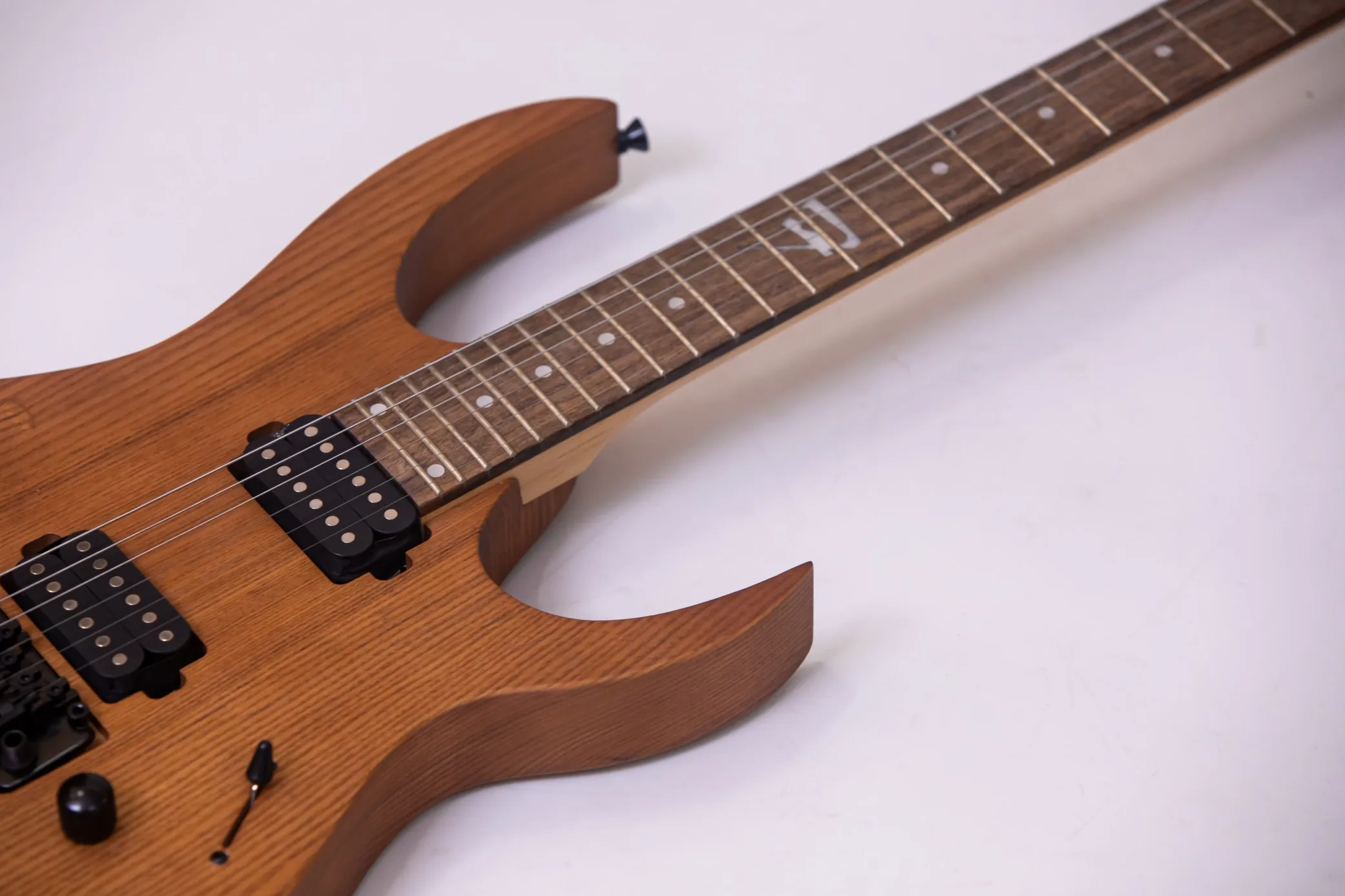 Custom-made model, the body has a cut-out, the pickups are double, single and double, the fretboard is with a floral pattern