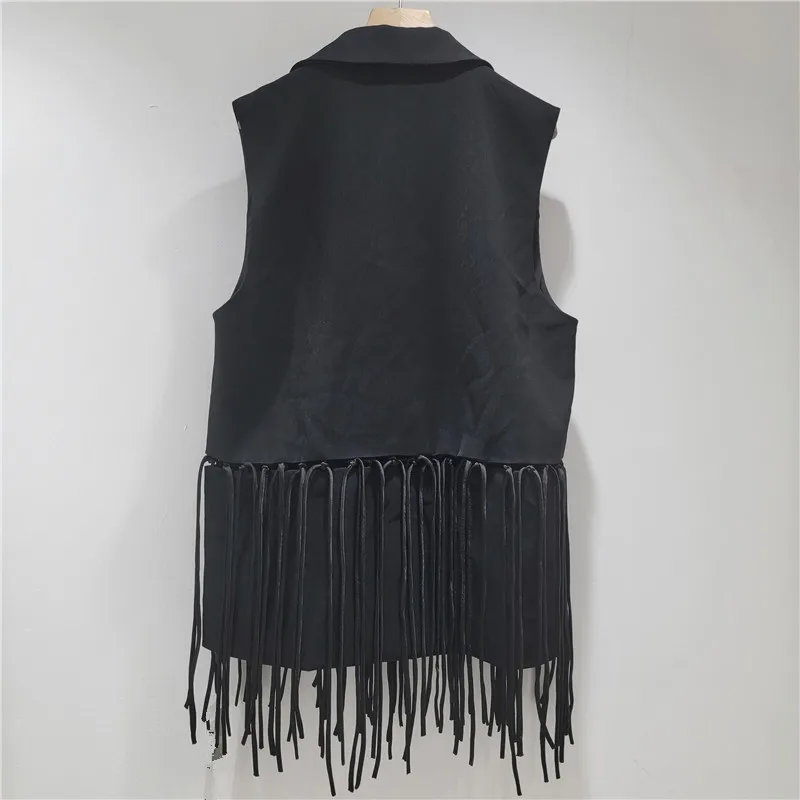

Chic black waistcoat with intricate openwork & fringe. A statement layering piece for elevated fall style.