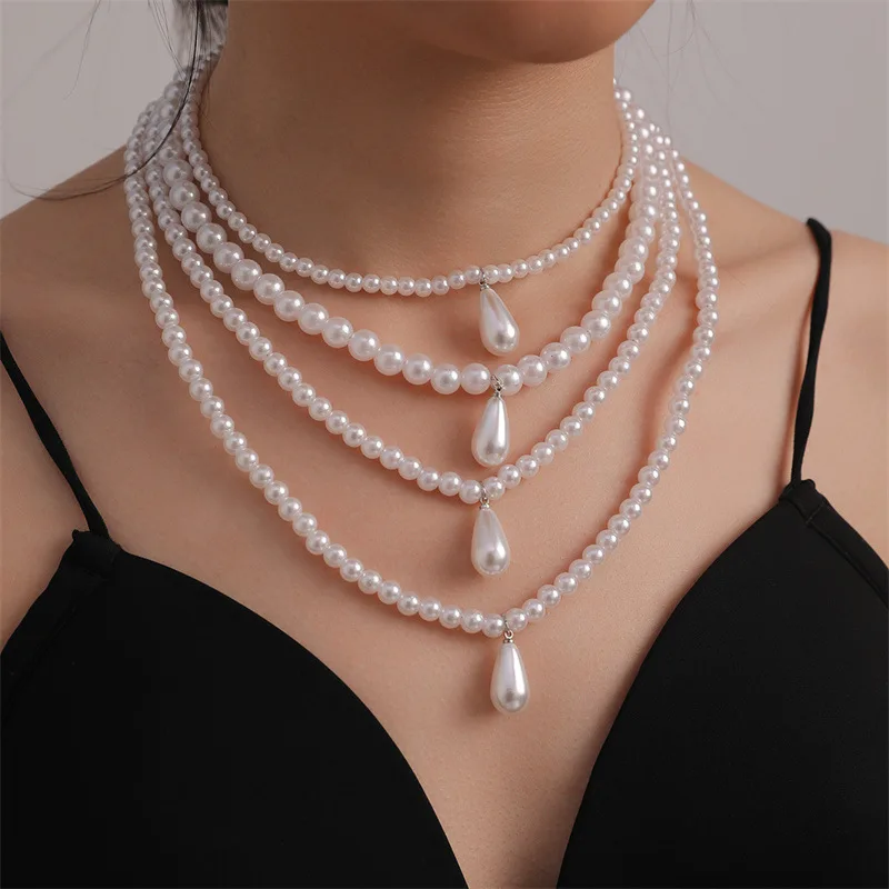 

Bohemian Faux Pearl Necklace Set: 4 Layering Chains with Teardrop Charms, Your Free-Spirited Uniform.