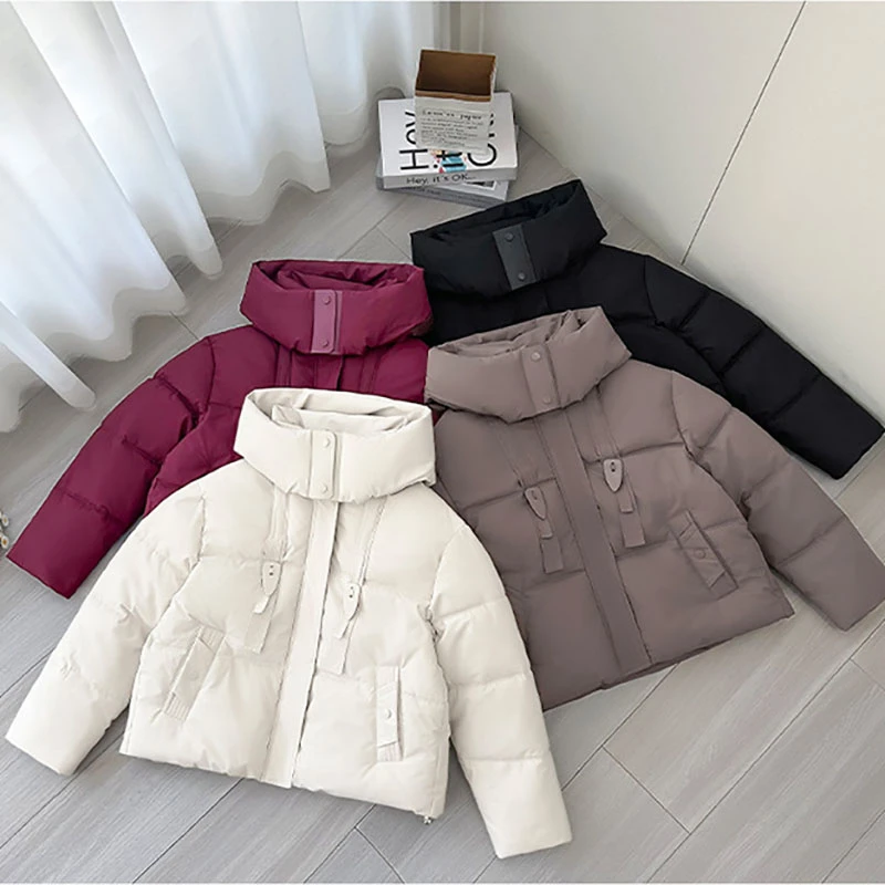 2025 Nuova giacca corta in cotone con design a nastro invernale da donna spessa Parka cappotti manica lunga tasche con cerniera con cappuccio abbigliamento casual tendenza