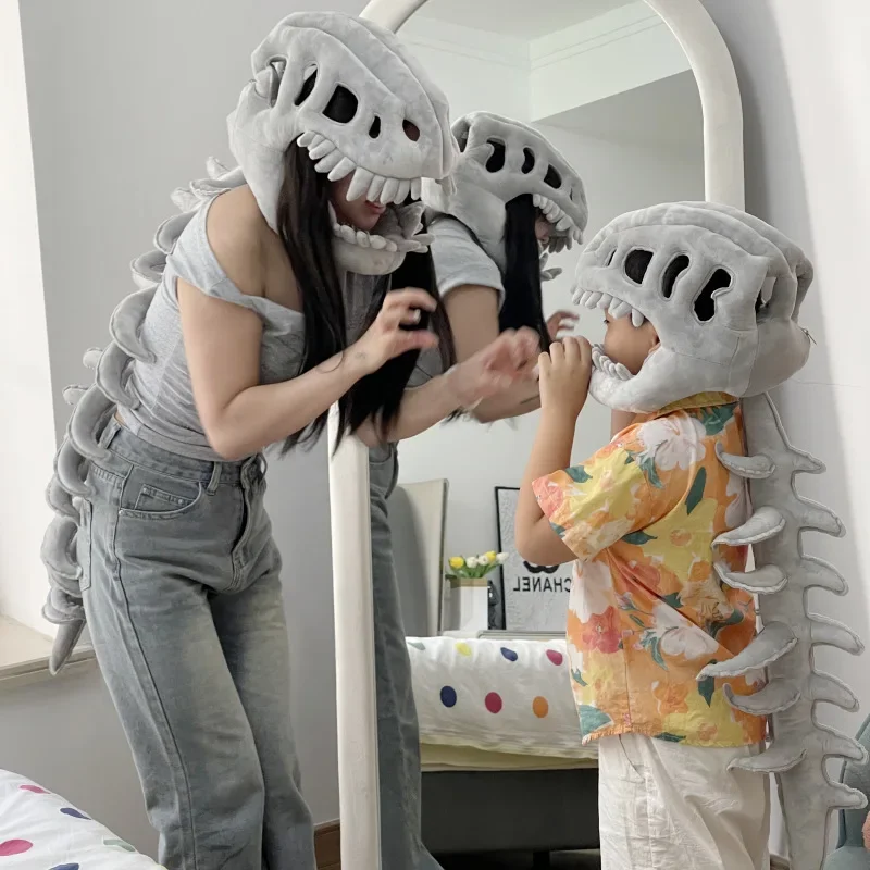 A Plush Dinosaur Skull With A Spine That Follows You