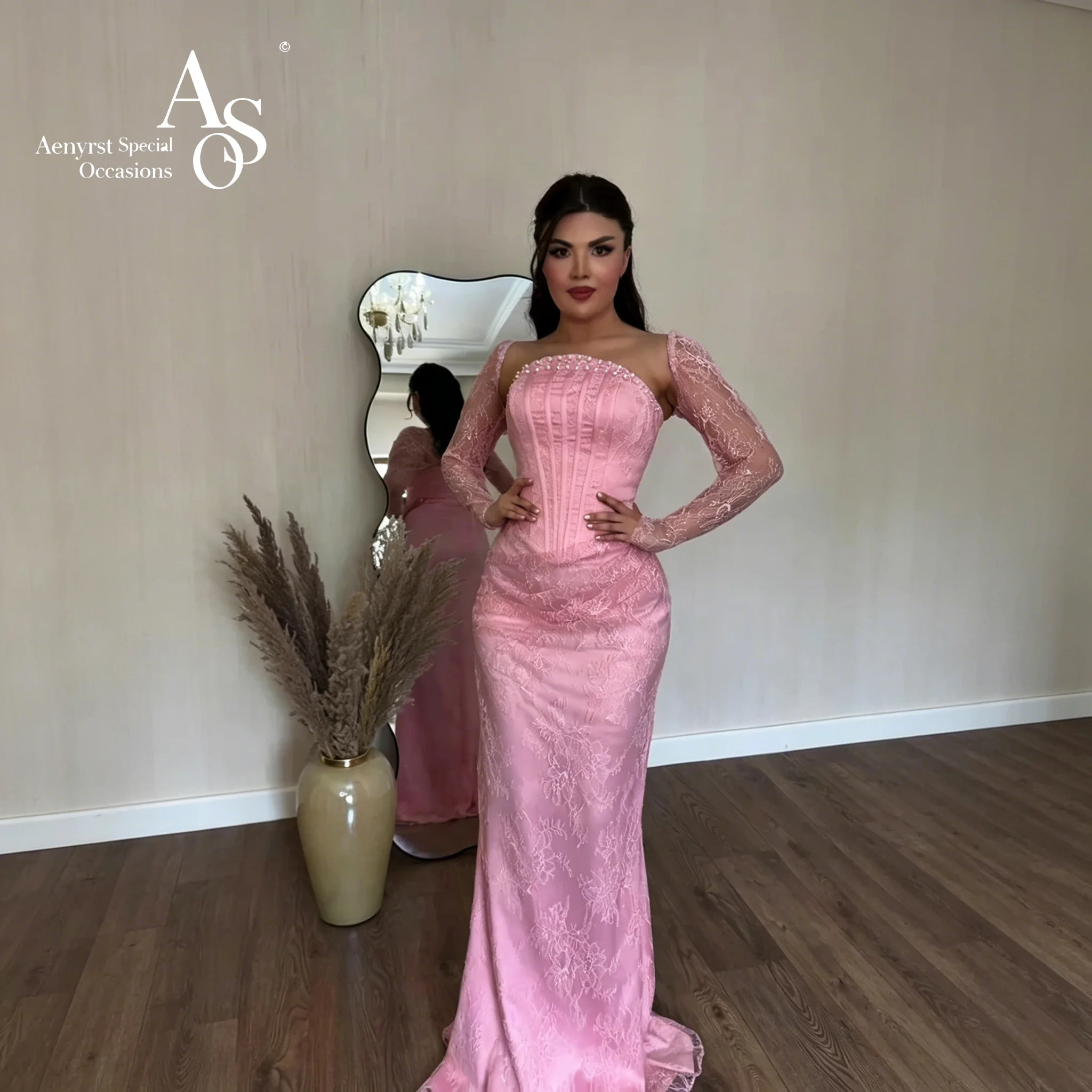 Elegant pink satin strapless fishtail off-shoulder floor-length evening gown with embroidery at the hem.
