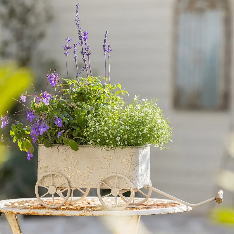 Vintage Wrought Iron Flower Cart with 3D Relief Design Four Wheeled Garden Trolley for Outdoor Courtyard Plant Pot Display