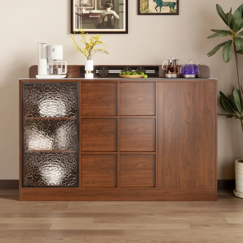The tea bar sideboard is integrated against the wall, and the living room is home with water