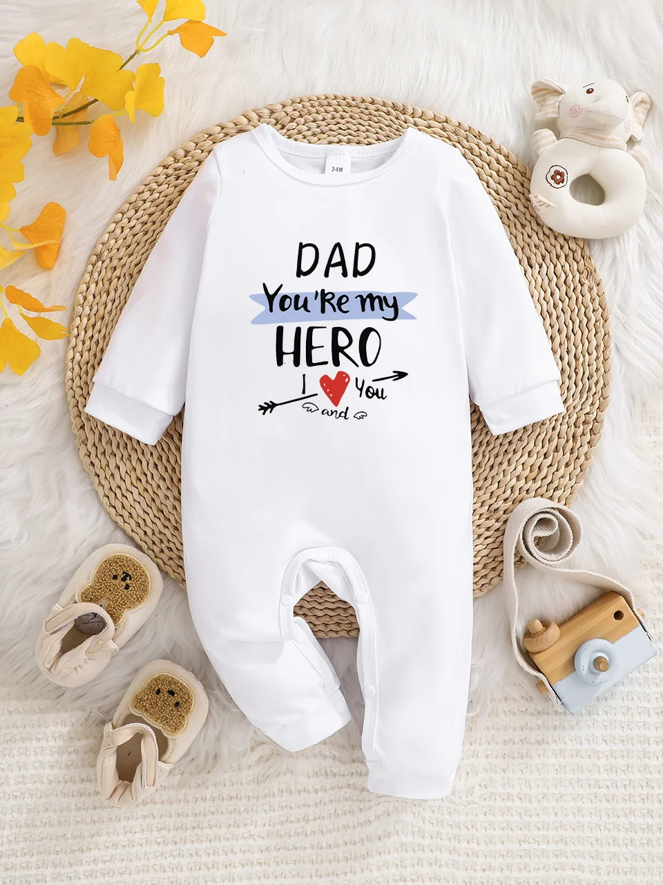 A baby long-sleeved onesie with interesting letter prints. It features a buttoned design for easy putting on and taking off, and