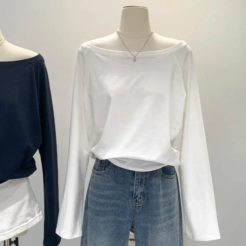 เสื้อเชิ้ตผ้าฝ้ายแขนยาวทรงเฉียงไหล่เดียวสำหรับผู้หญิง สไตล์ฤดูใบไม้ร่วงฤดูหนาว ดีไซน์ไหล่กว้างแบบทรัฟเฟิล