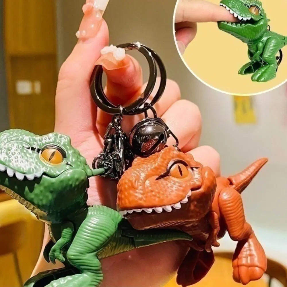漫画恐竜ティラノサウルスレックス人形キーホルダー手を噛む恐竜の手を噛む恐竜キーリングファッションプラスチック