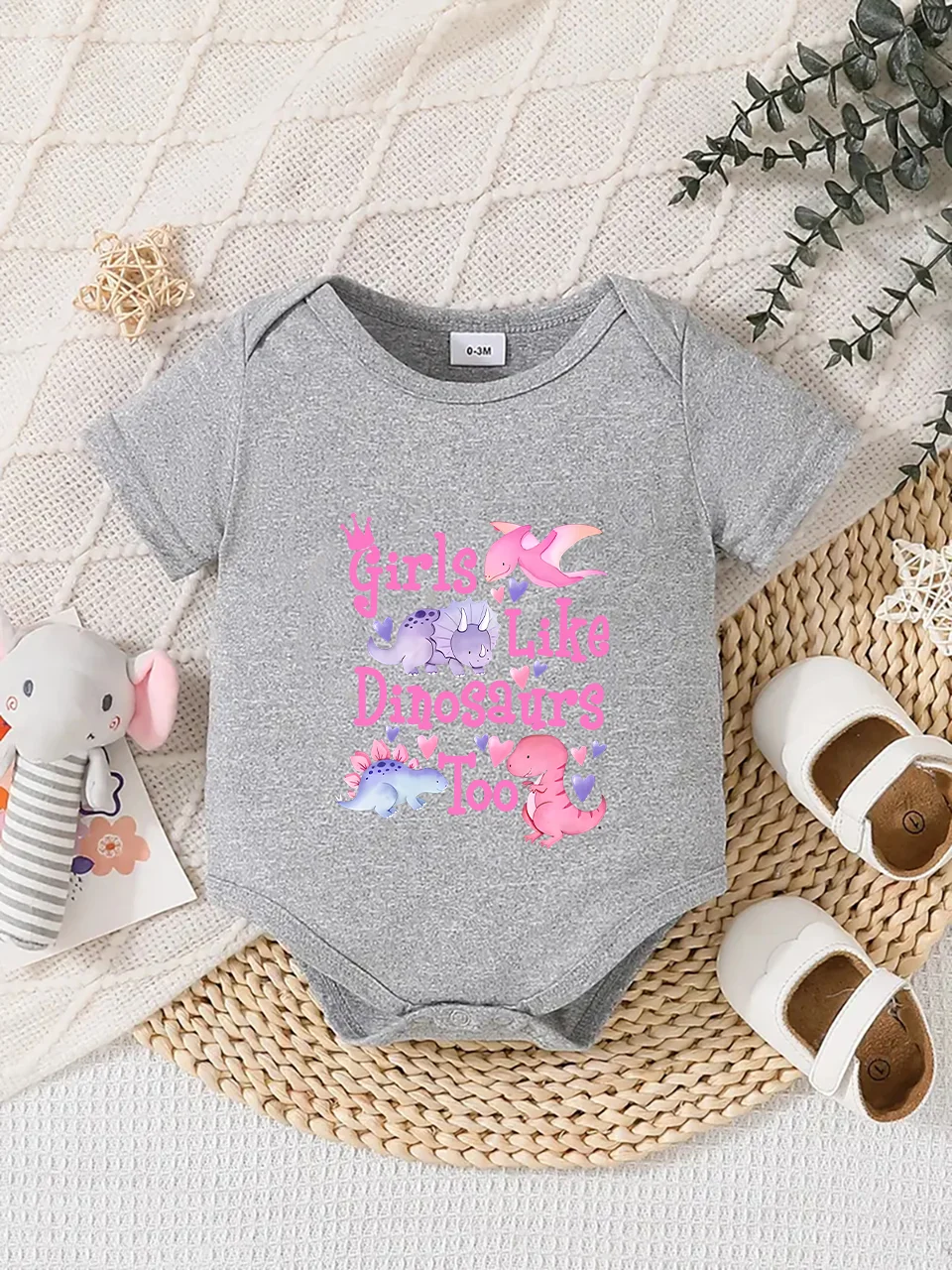 Playful letter-printed baby short-sleeve triangle bodysuit. Button closure for easy dressing