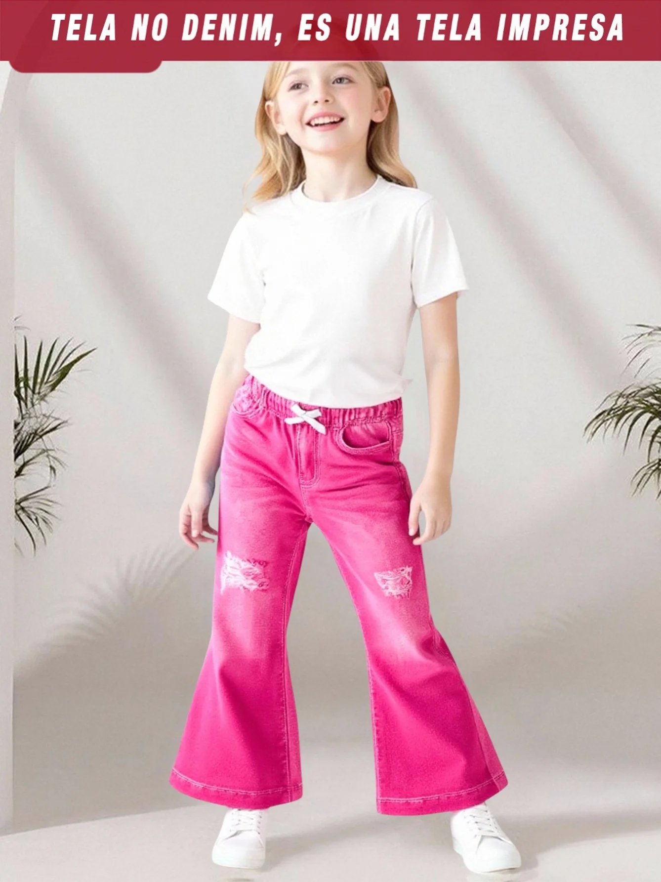 Girls' long pants in bright rose pink, featuring cute ripped details and a fitted flare leg design. The retro yet playful style,