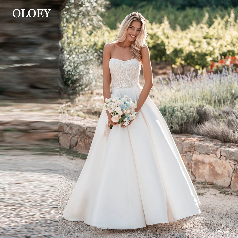 

OLOEY Elegant Ivory Satin A Line Wedding Dress Sweetheart Floor Length Bridal Gown Beads Button Back Sweep Train Customized