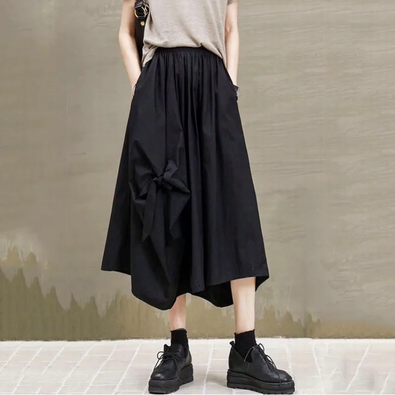 Faldas largas de primavera para mujer, faldas por debajo de la rodilla con bolsillo y lazo negro Vintage para mujer, faldas plisadas irregulares de cintura alta, ropa de verano para mujer