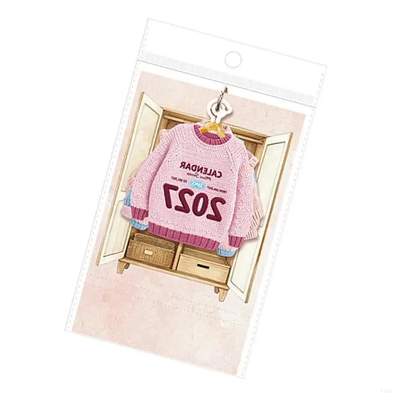 CORA 2027 Mini Desk Calendar with Monthly Date Grids, Garment-Shaped Pages, Hanger-Style Headers, and Printed Knit Artwork