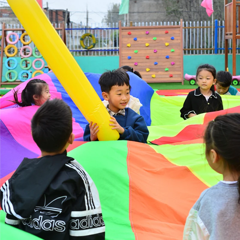 I bambini all'aperto giocano con la tenda del giocattolo dell'arcobaleno del paracadute giochi per bambini parco giochi per l'asilo divertimento delle attività di Team Building della cooperazione