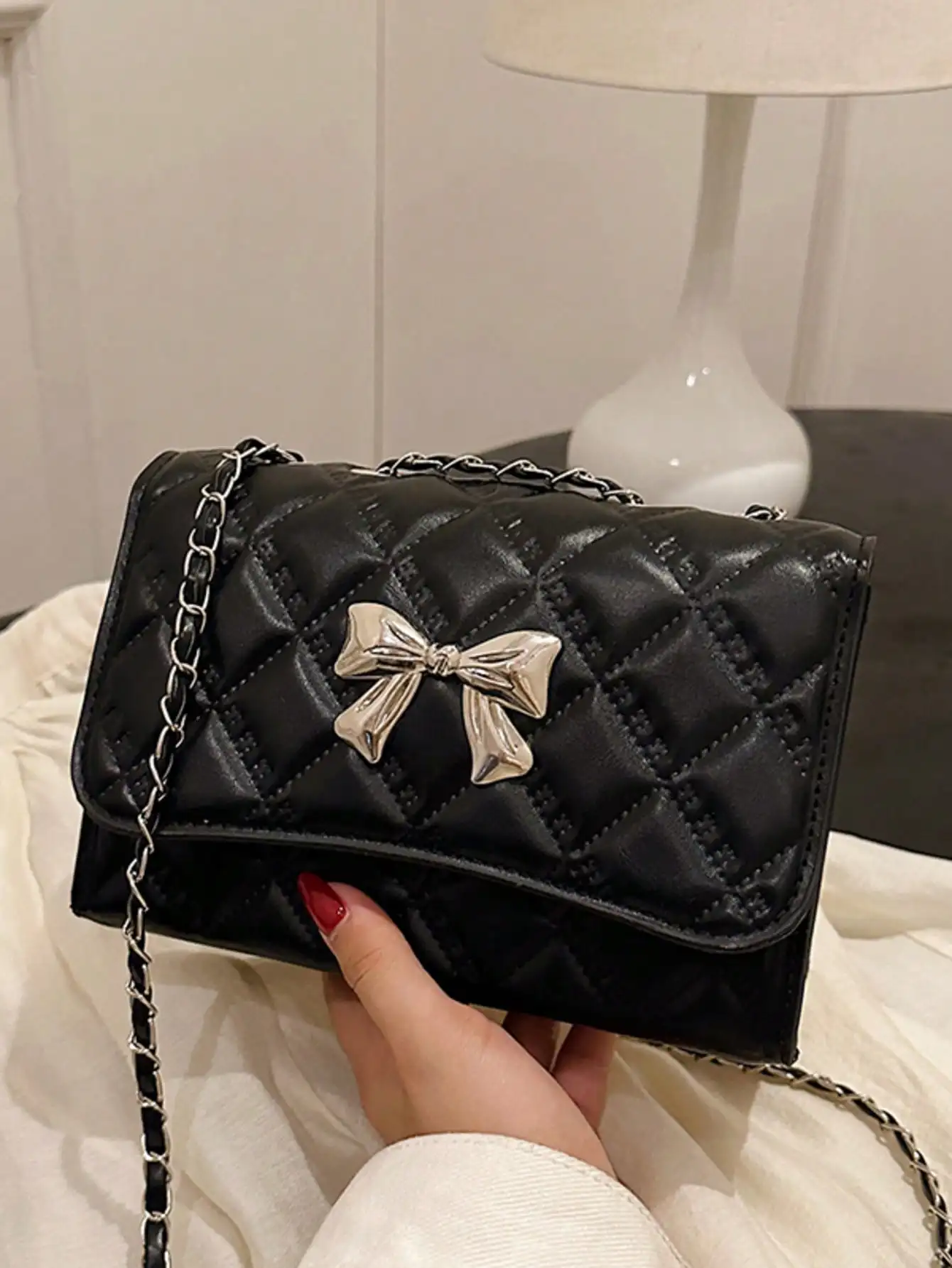 

Black Quilted Mini Flap Shoulder Bag with Silver Bow Charm and Chain Strap