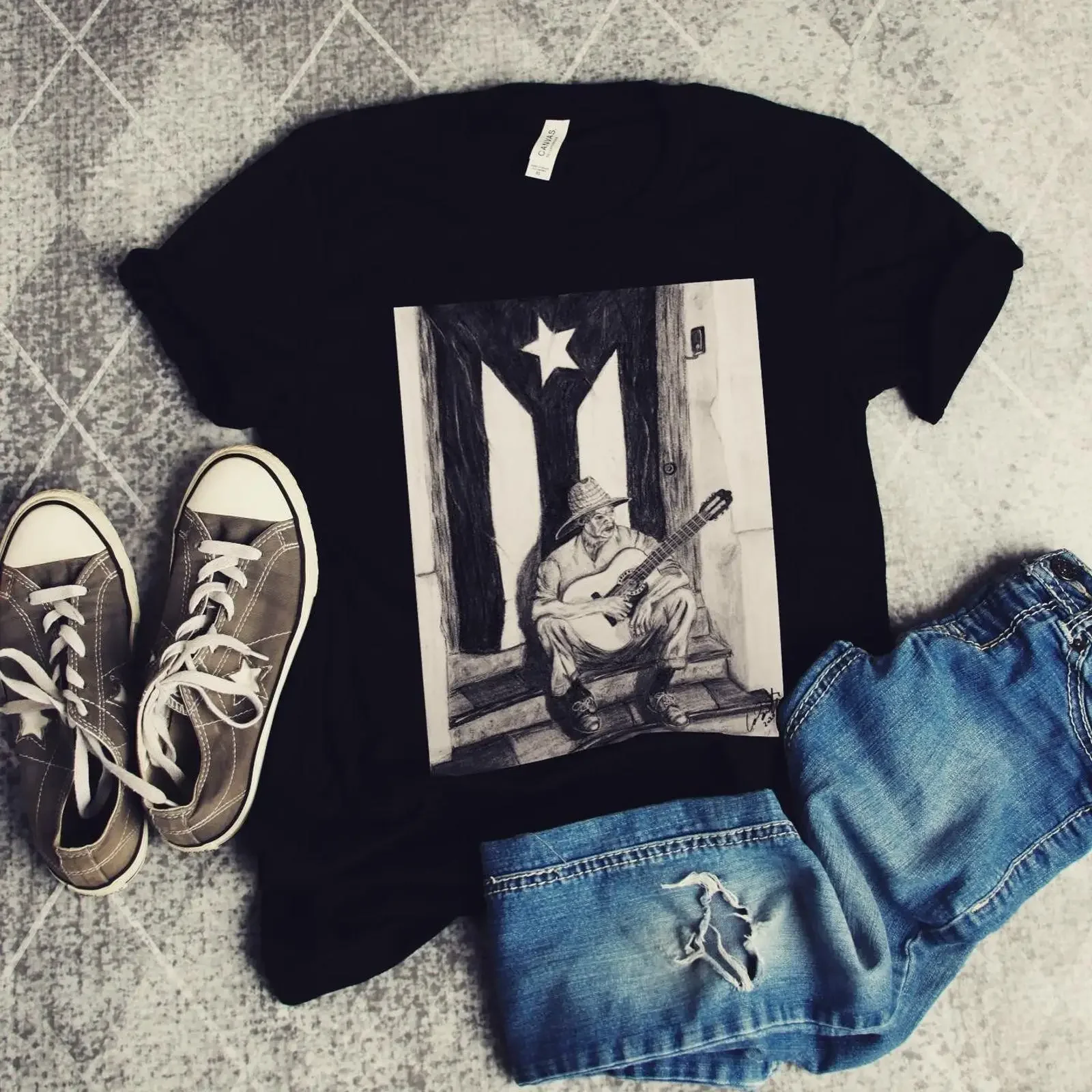 May include Black t shirt with a graphic of man playing guitar in front Puerto Rican flag vintage Washed fashion