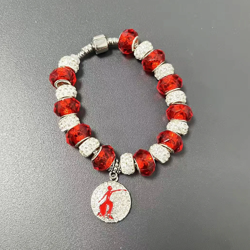 bracelet composed of red and white beads featuring Delta Greek letter shield and violet pendant.