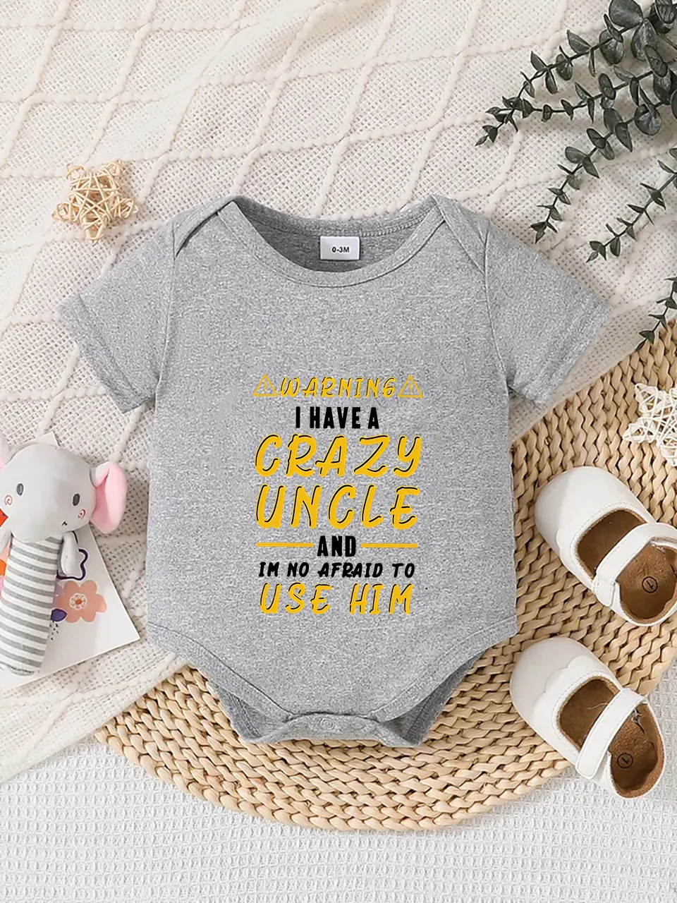 Playful letter-printed baby short-sleeve triangle bodysuit. Button closure for easy dressing, machine washable
