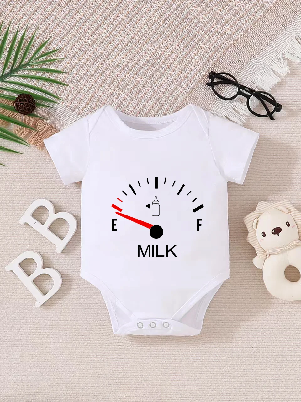 Playful letter-printed baby short-sleeve triangle bodysuit. Button closure for easy dressing, machine washable