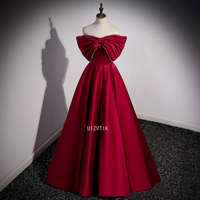 فستان حفلة موسيقية أنيق باللون العنابي للنساء بدون أكتاف بفيونكة كبيرة مناسبة للحفلات المسائية فساتين مناسبة رسمية مخصصة