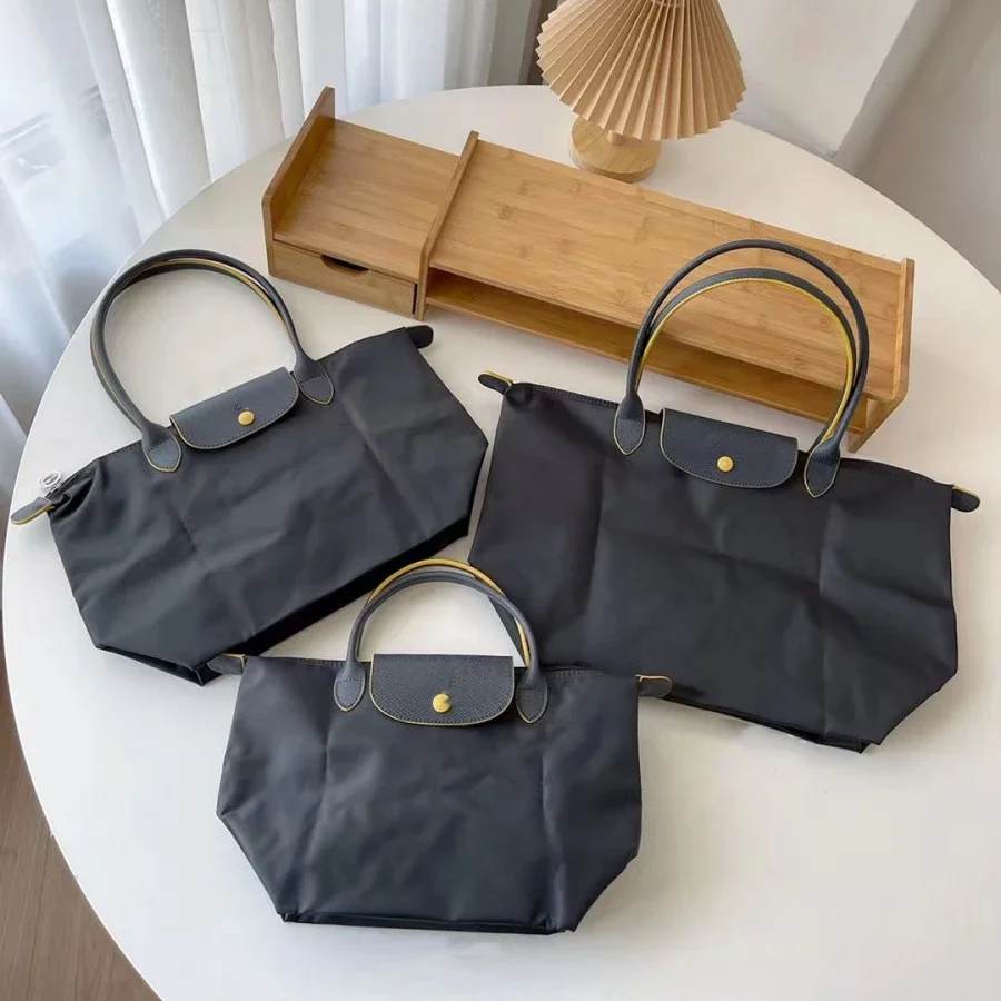 2025 Bolsos de mano de nailon plegables de alta capacidad, bolso clásico para mujer, bolsos de hombro a la moda, bolso de compras con bola de masa para mujer