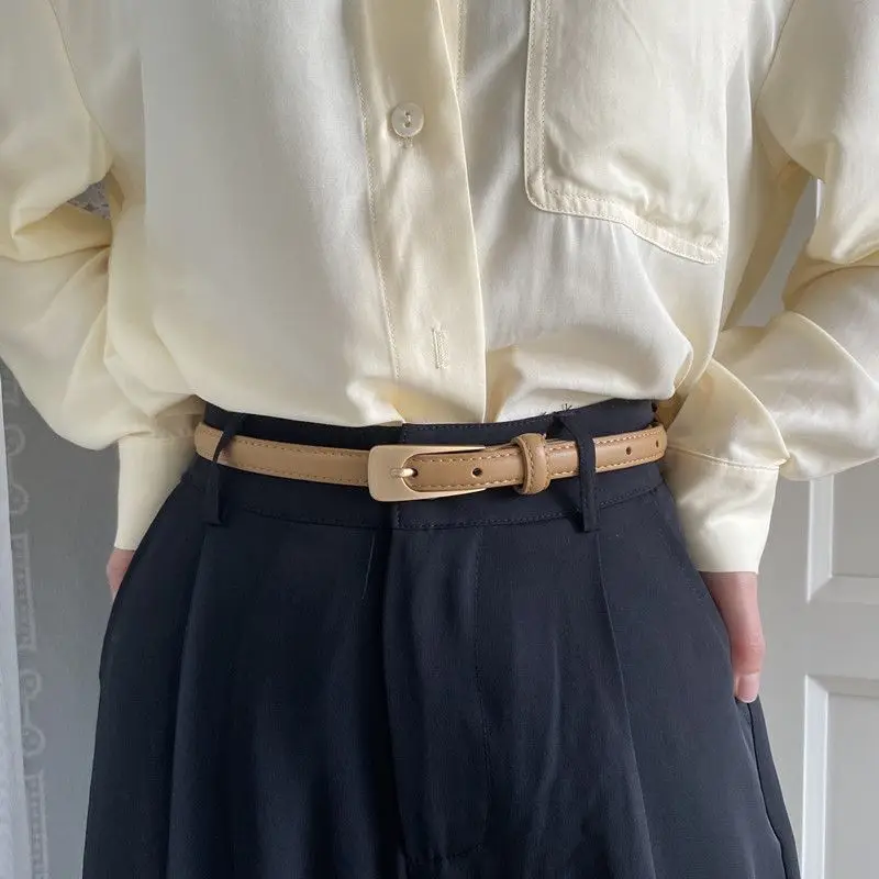 Slim beige waist belt with smooth leather square buckle and adjustable waistband, suitable for matching pants and skirts