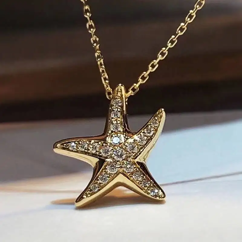 Huitan Halskette mit Seestern-Anhänger für Damen, goldfarben, für Partys und Alltag, ausgefallenes Accessoire, vollständig mit glänzenden Zirkonia besetzt, trendiger Schmuck
