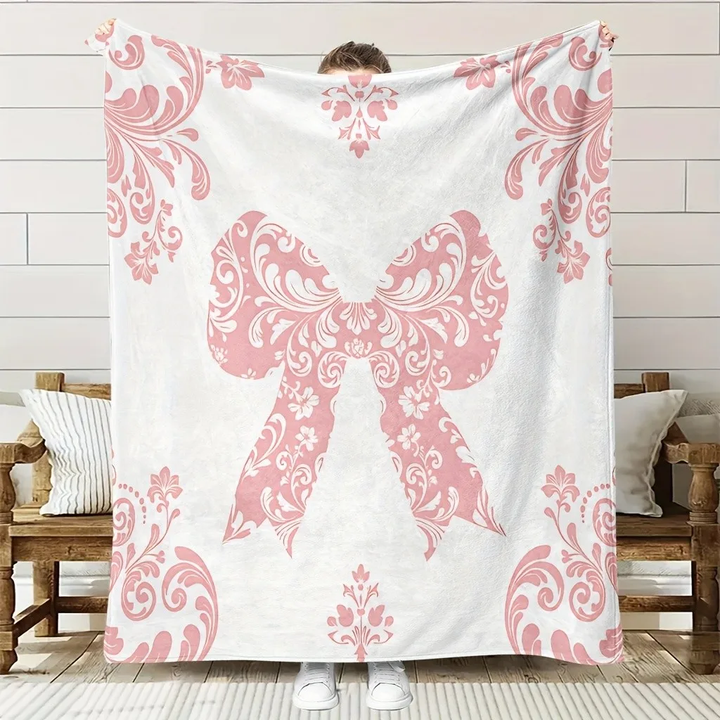 Pink bow-patterned blanket, polyester fabric, machine washable, suitable for bedroom, living room, and sofa decoration.