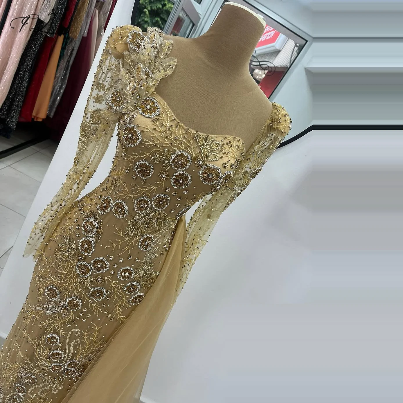 Mermaid evening dress with rhinestone flower bead embellishment side tulle train long sleeves champagne gold long ball gown