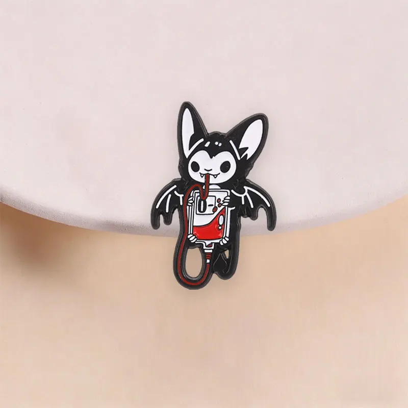 Vampire Bat Holding Blood Bag Enamel Pin, Cute Goth Brooch With Straw For Halloween And Dark Kawaii Everyday Style