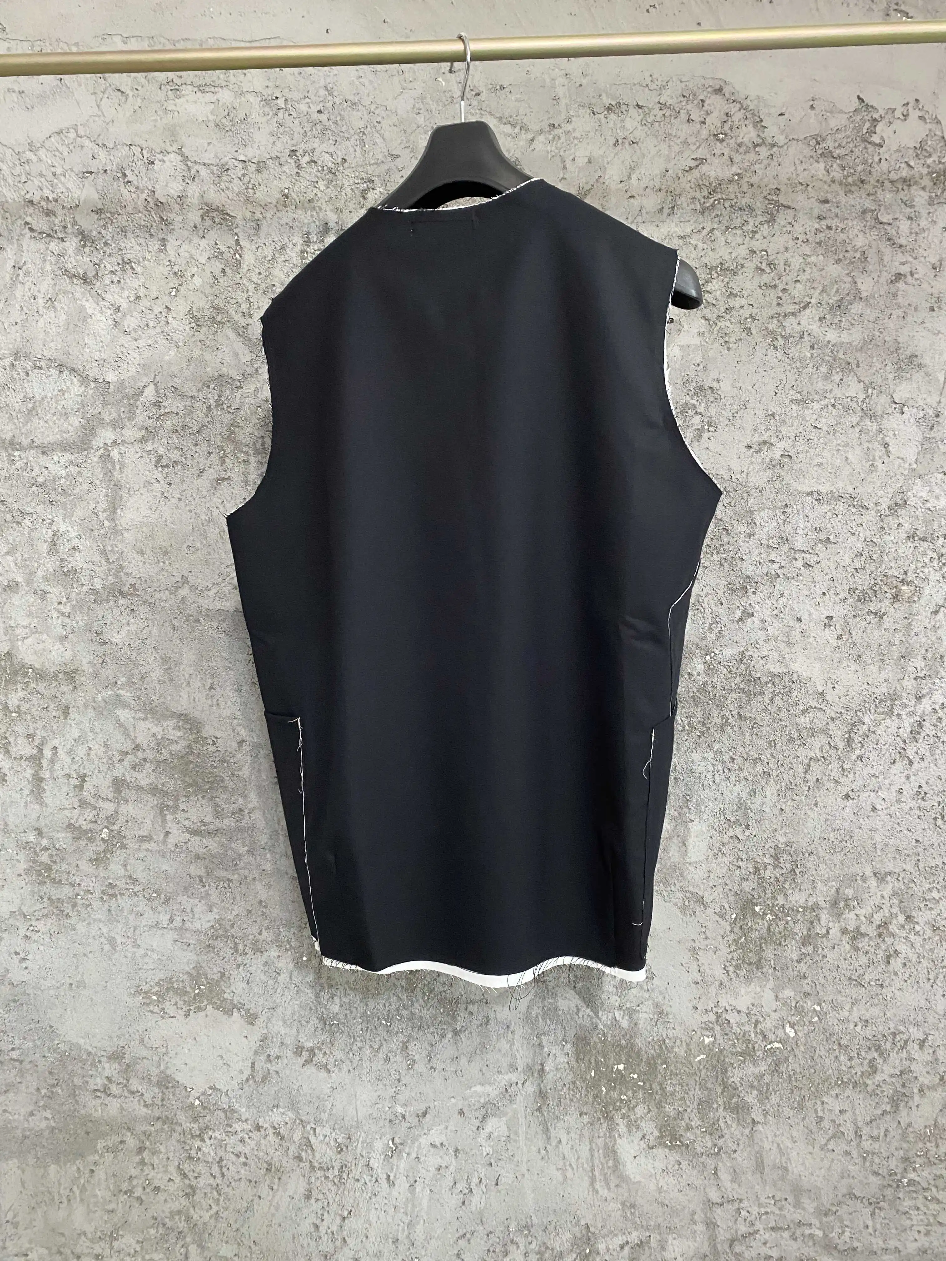 

TOP-YAMAMOTO, a Japanese independent designer, custom-cut collarless wool fringed vest with a stylish look