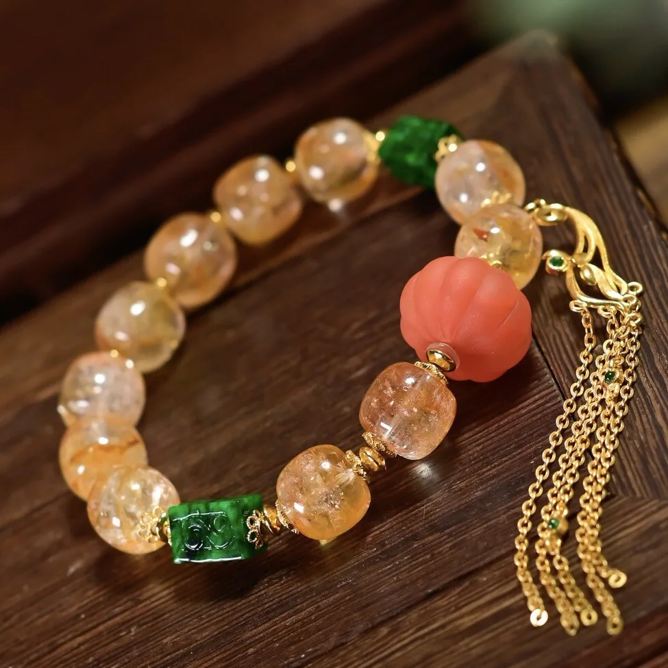 

Natural Yellow Hematoid Quartz Bracelet with A-grade Carved Jadeite, Red Agate Pumpkin Bead & Silver Tassel Charm