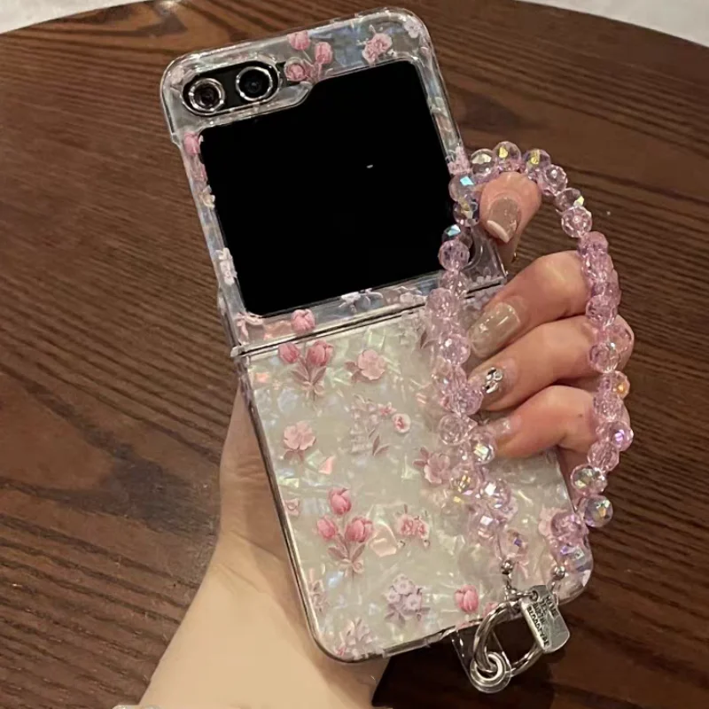 

Luxury Laser Shell Patterned Floral Cover For Samsung Galaxy Z Flip 7 Luxury Wrist Chain Case For Samsung Z Flip 6 5 4 3 Cases