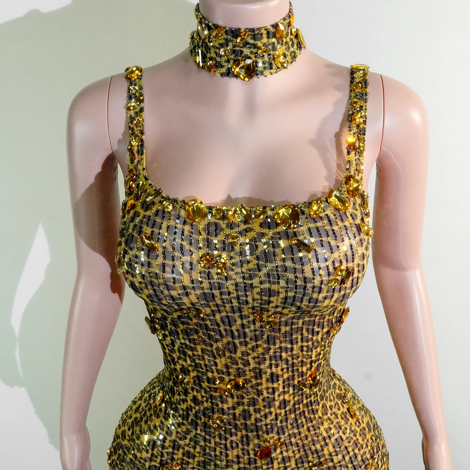 

A sexy leopard-print halter fitted mini skirt paired with yellow rhinestone stage performance costumes for a birthday party drag