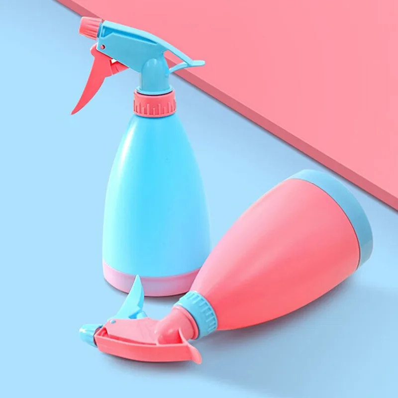 

Garden tool: candy-colored spray bottle for watering, hand-operated flower sprinkler, plastic sprayer, small bottle.