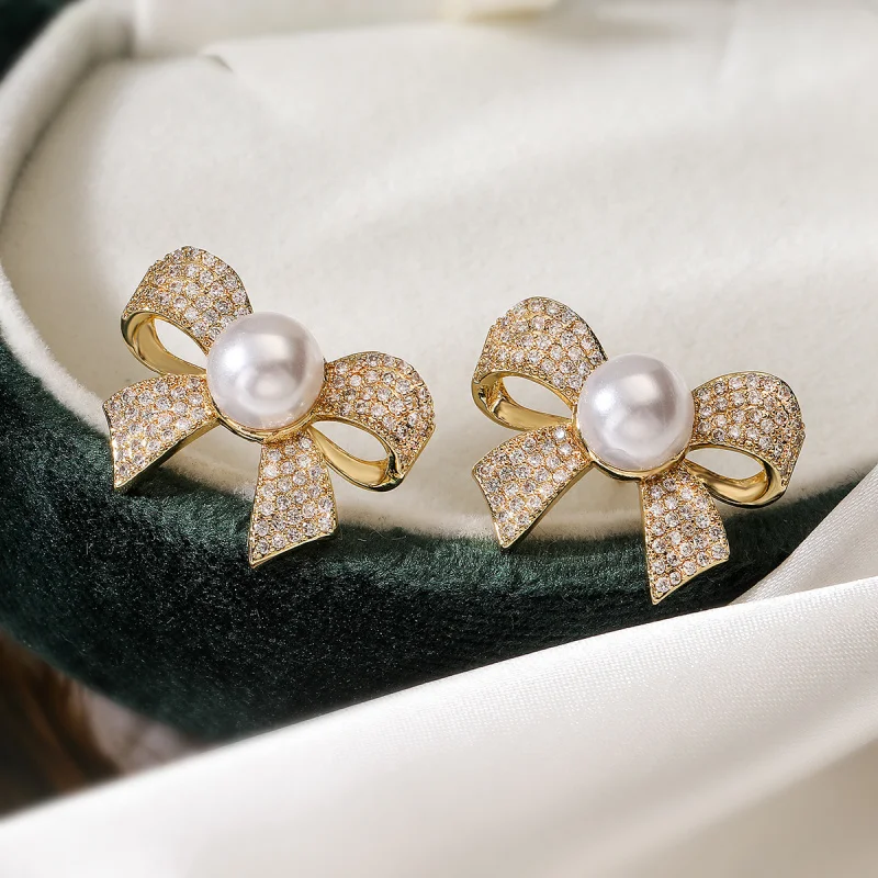 

European and American Fashion Exquisite Copper Plated 18K Gold Inlaid Zircon Pearl Bowknot Earrings for Women Light Luxury Sweet