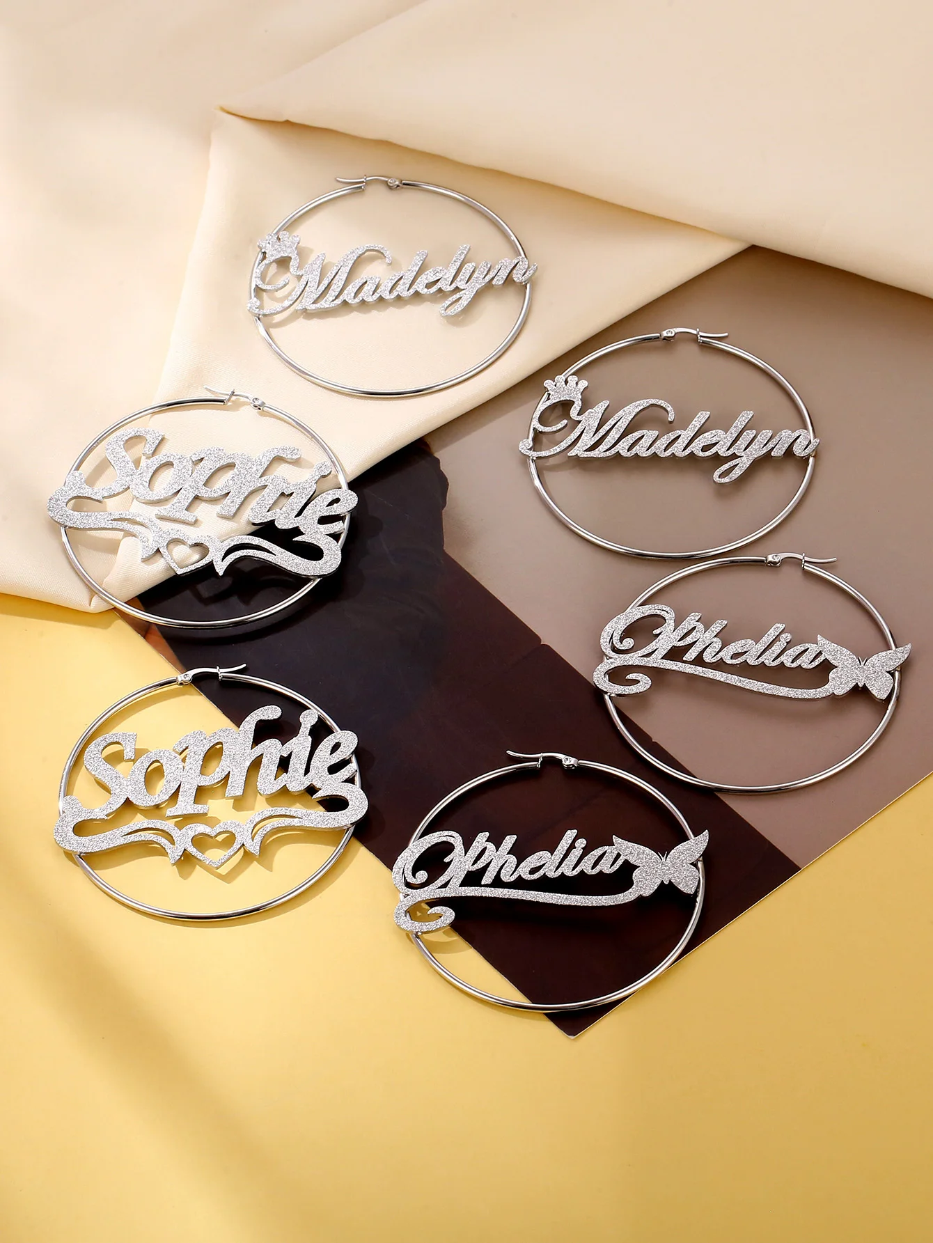 

Shiny personalized stainless steel name hoop earrings, made using sandblasting technology to create stylish custom stainless ste