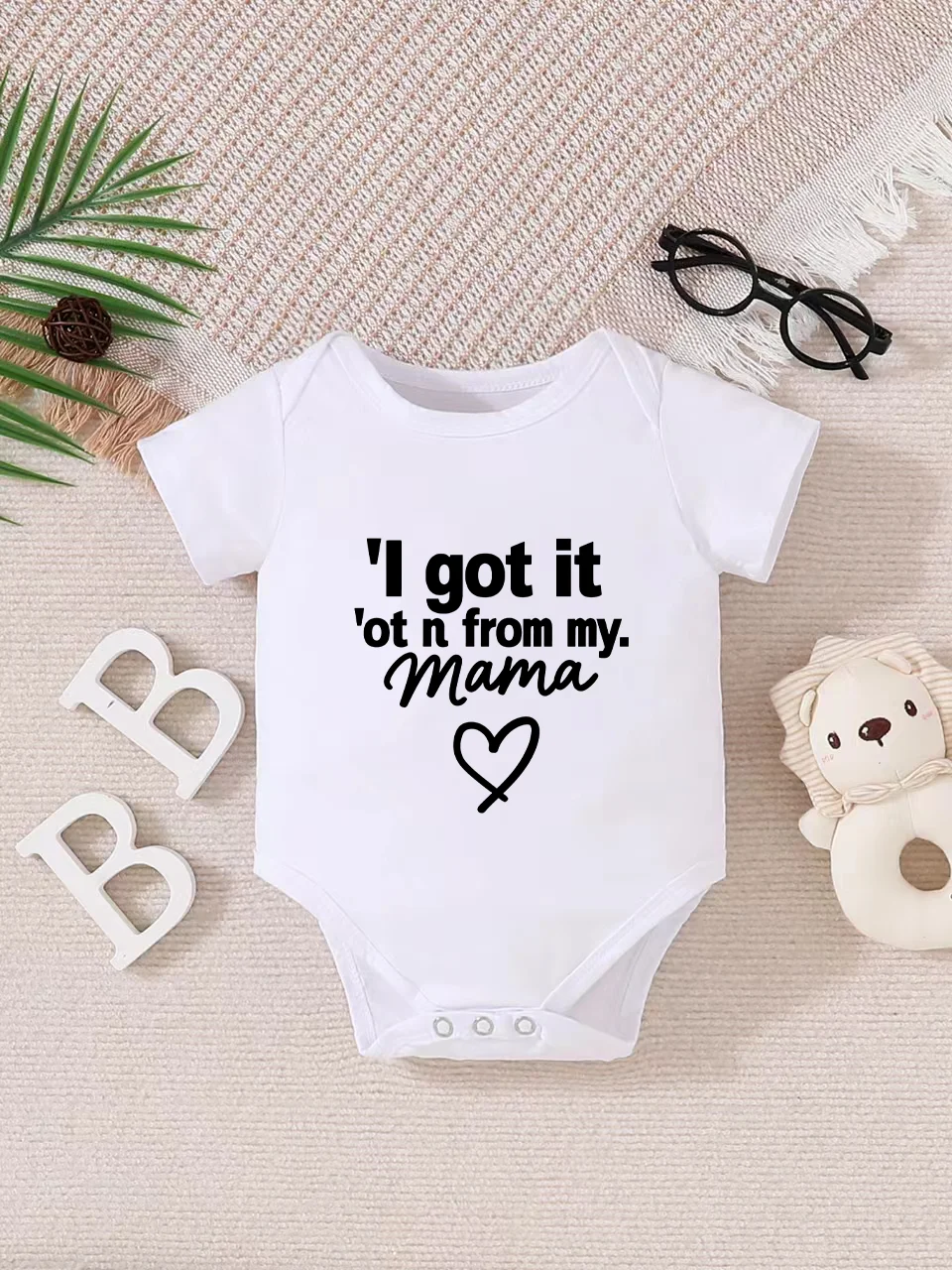 Playful letter-printed baby short-sleeve triangle bodysuit. Button closure for easy dressing