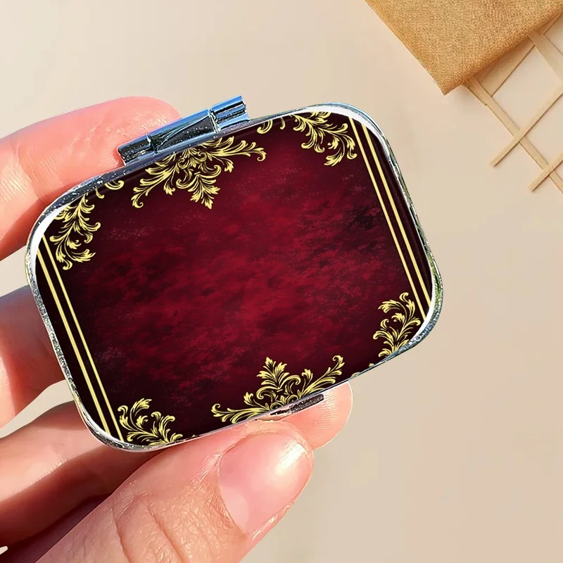 One Red Decorative Golden Square Pill Container with Two Compartments, Perfect for Organizing This Portable Storage Box Is Stylish and Compact, Making It Ideal for Travel and Easy to Carry in Your Wallet or Pocket, Great as a Travel Gift.