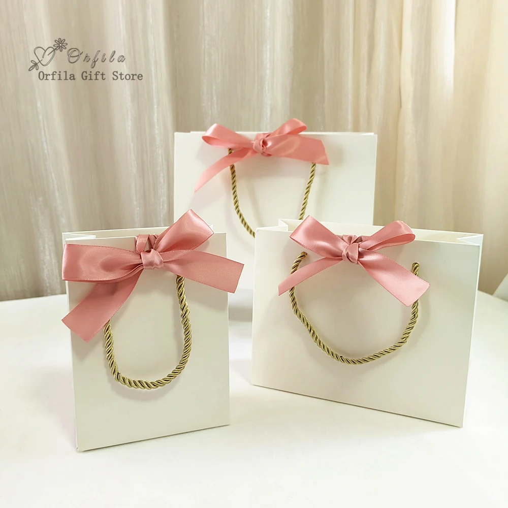 

New pink gift bag box wedding party favors bag kraft paper bags packaging Ornament Pajama Book golden Handle With Ribbon