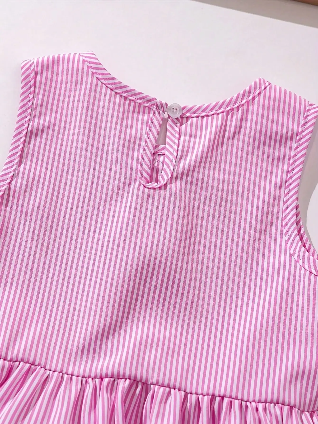 Modisches zweiteiliges Set für Mädchen: rosa-weiß gestreifter Rundhalspullover mit Schnürung, Schleife und Rüschenrand + rosa gestreifte Schmetterlings-Shorts. – Detail 7