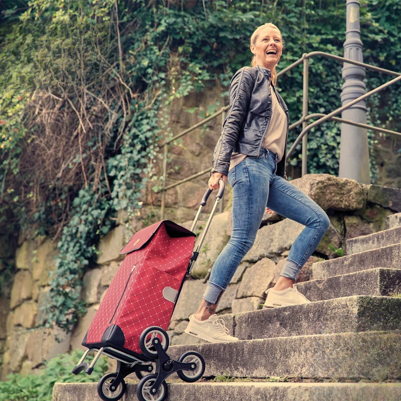 

Portable folding shopping cart for climbing stairs to buy food, driver pulling cart and trolley.