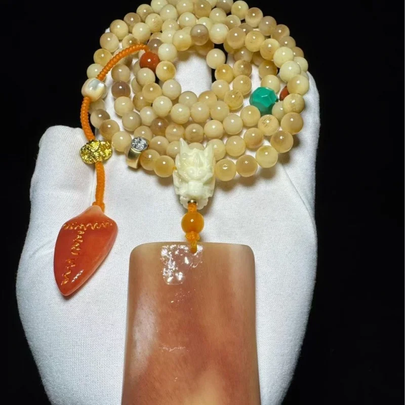 

red blood pendant, jade-like bone necklace, a hand-held artifact with texture and full grain
