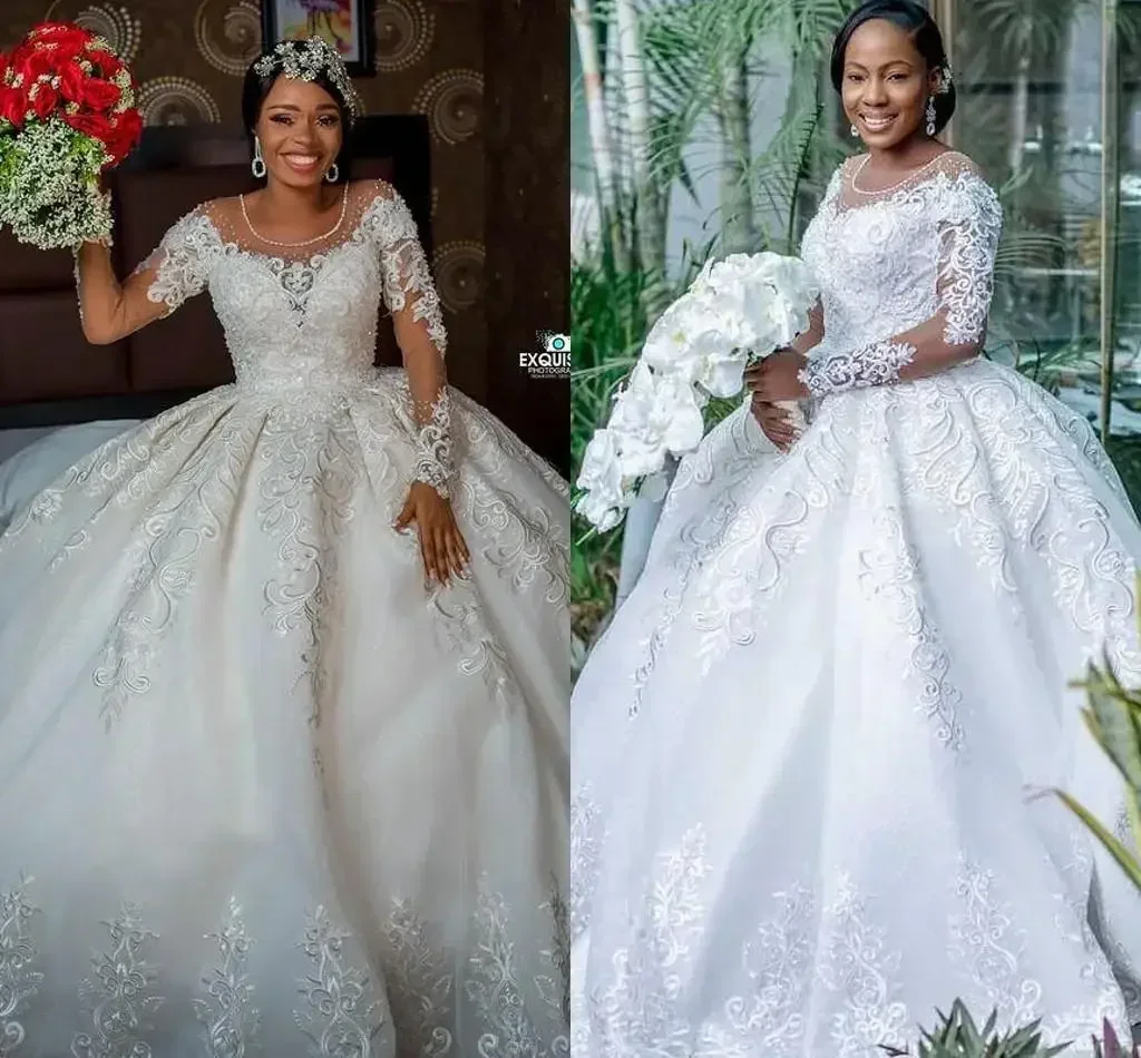 فساتين زفاف مخصصة مقاس كبير 2025 فاخرة بأكمام طويلة مزينة بالدانتيل مطرز برقبة شفافة أفريقية فستان زفاف الأميرة