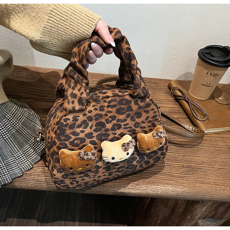 Sanrio Hello Kitty bolso portátil de moda para mujer muñeca con estampado de leopardo de dibujos animados casual versátil simple bandolera de hombro