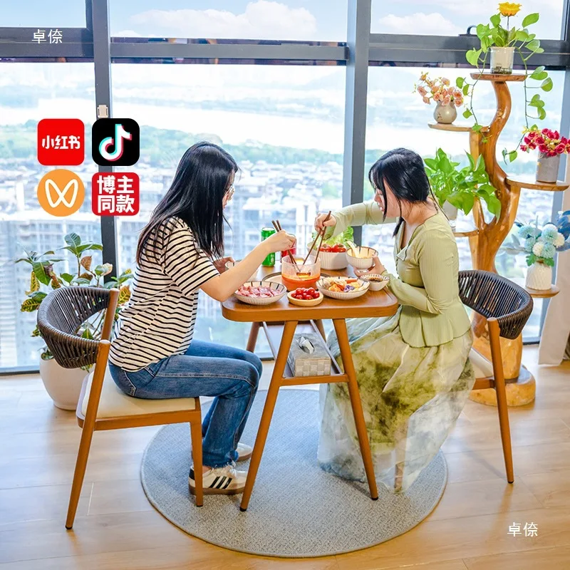 Balcony small tables and woven and chairs surrounding stove brewing tea one tabl two  Internet celebrity home outdoor